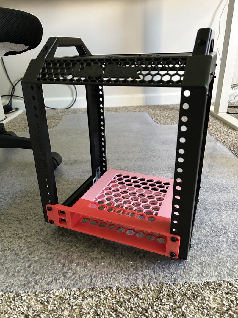Black Labrax rack with a red and pink 3D-printed honeycomb shelf